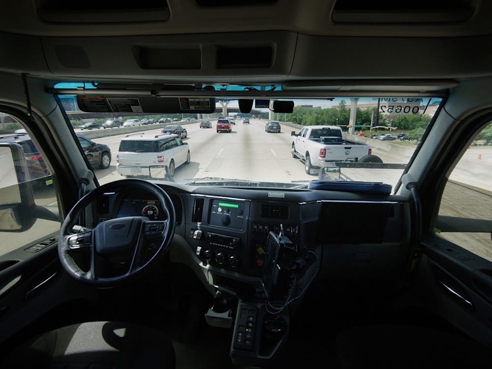 Inside the cab of an autonomous truck on the highway